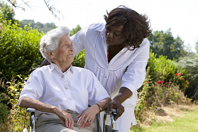 senior woman and caregiver looking at each other